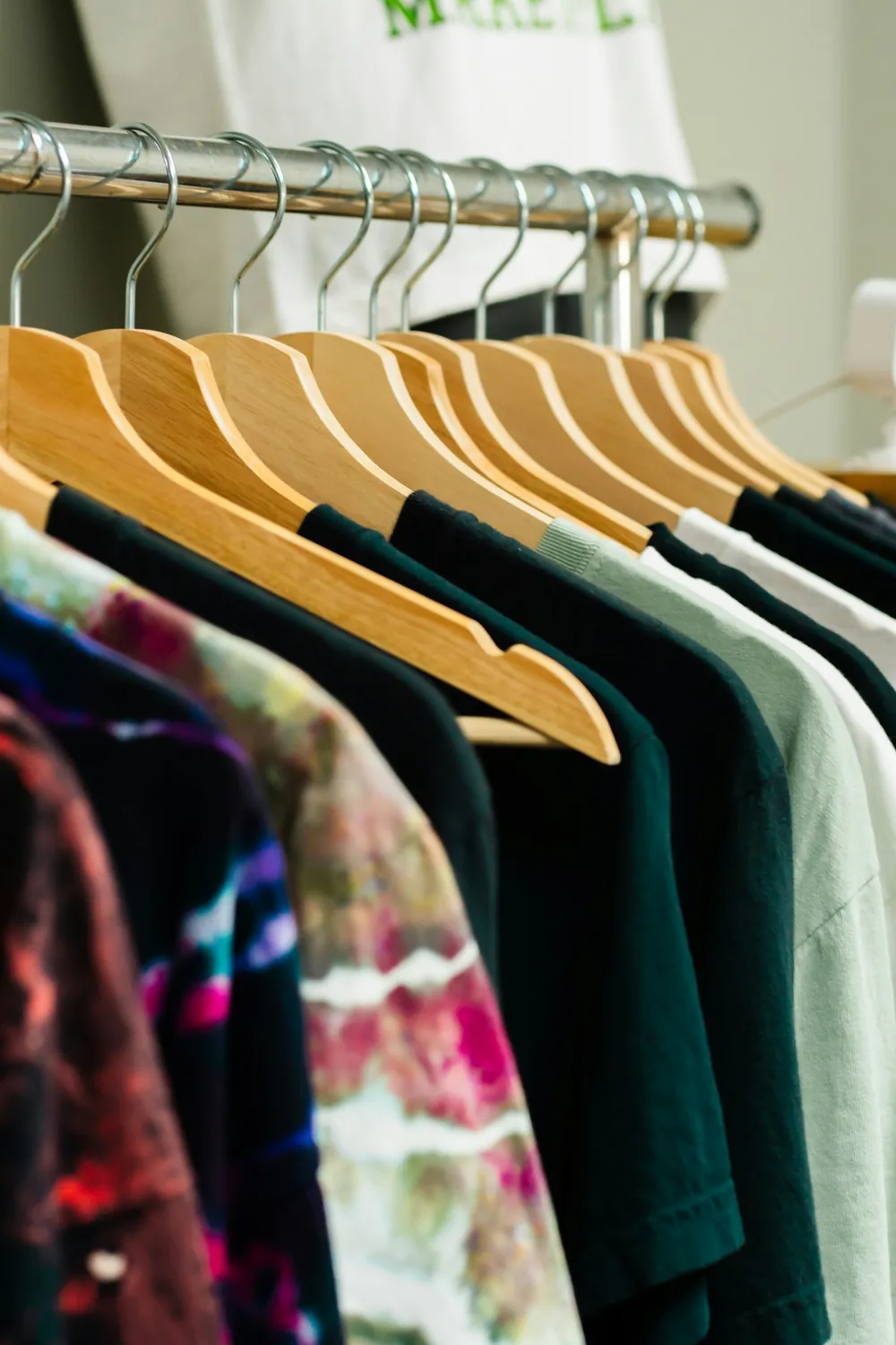 Rack of printed T-shirts on hangers